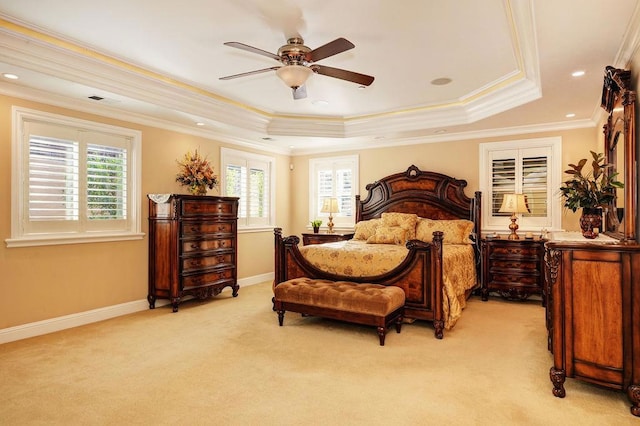 bedroom featuring crown molding, ceiling fan, a raised ceiling, and light carpet