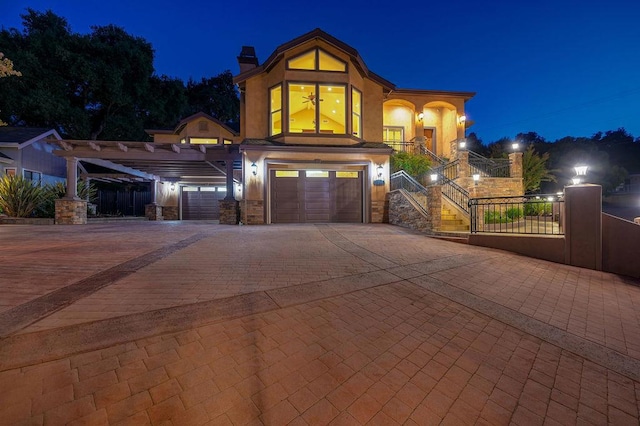 view of front of home featuring a garage and a carport