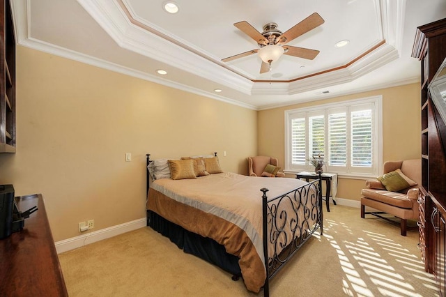 bedroom featuring ceiling fan, ornamental molding, and a tray ceiling