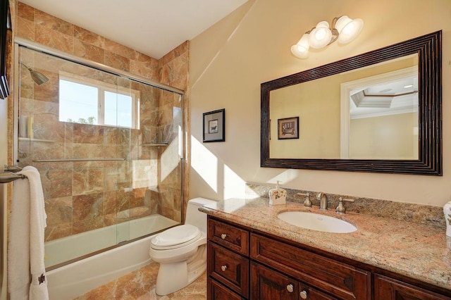 full bathroom featuring bath / shower combo with glass door, vanity, and toilet