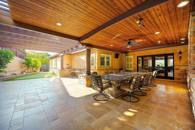 view of patio / terrace with exterior bar, ceiling fan, and french doors