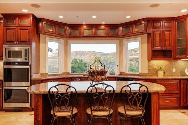 kitchen featuring a center island, stainless steel appliances, a breakfast bar, and a mountain view