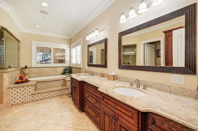 bathroom with crown molding, tile patterned floors, vanity, and tiled tub