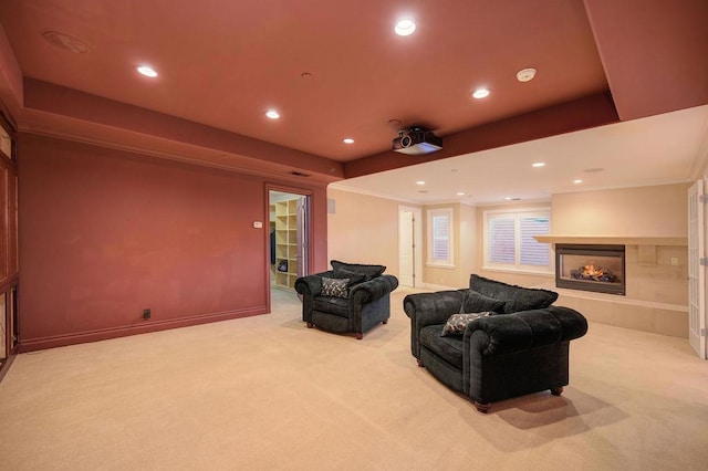 carpeted cinema room with a tile fireplace