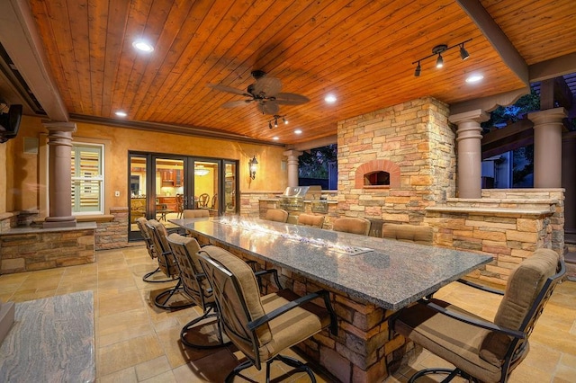 view of patio / terrace with ceiling fan, exterior kitchen, and an outdoor bar