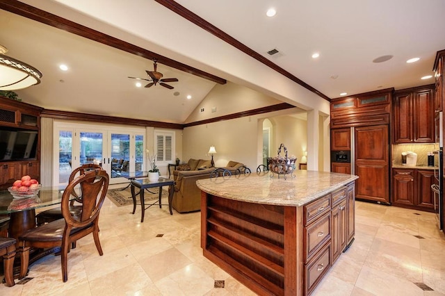 kitchen featuring vaulted ceiling with beams, light stone counters, paneled built in fridge, a kitchen island, and french doors