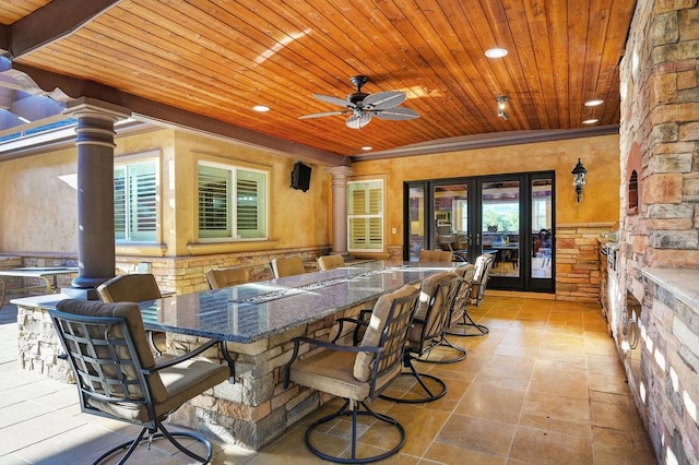 view of patio / terrace with french doors, ceiling fan, and exterior bar