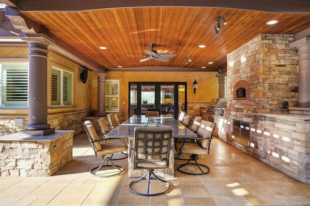 view of patio / terrace featuring a grill, french doors, ceiling fan, and exterior kitchen