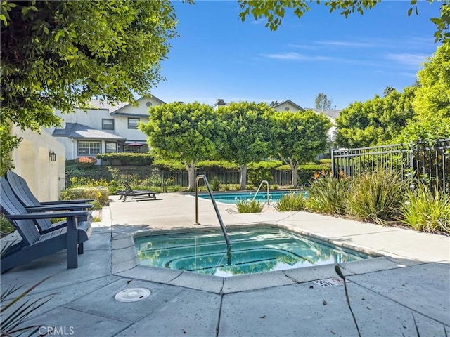 view of pool featuring a patio area and a community hot tub