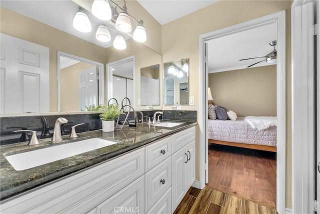 bathroom featuring ceiling fan, wood-type flooring, and vanity