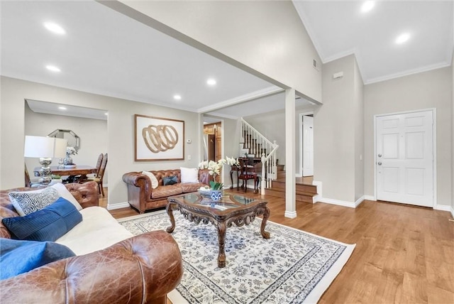 living room featuring crown molding and light hardwood / wood-style floors