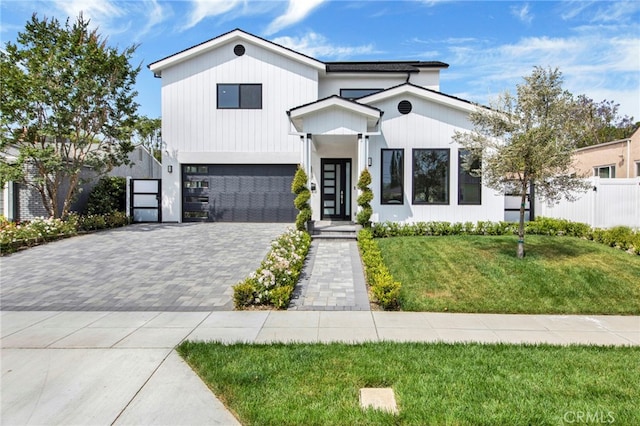 modern farmhouse with a front yard and a garage