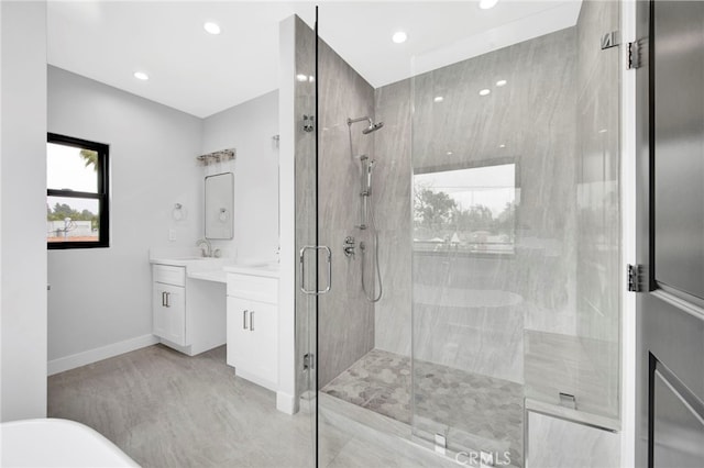 bathroom with hardwood / wood-style floors, vanity, and an enclosed shower