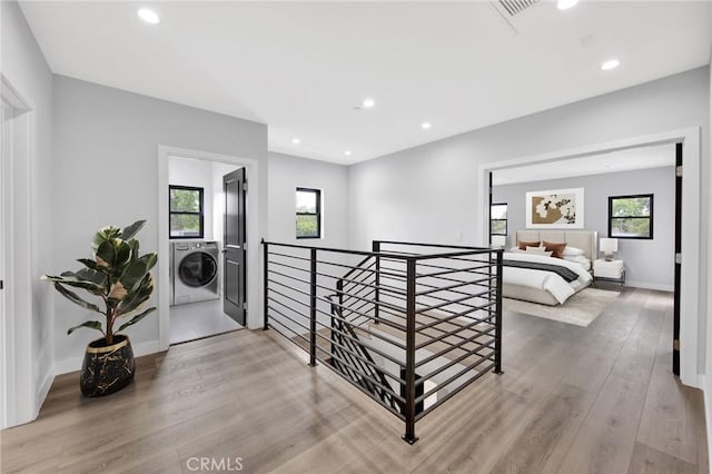 corridor featuring light hardwood / wood-style flooring and a healthy amount of sunlight