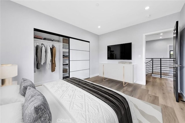 bedroom featuring a closet and light wood-type flooring