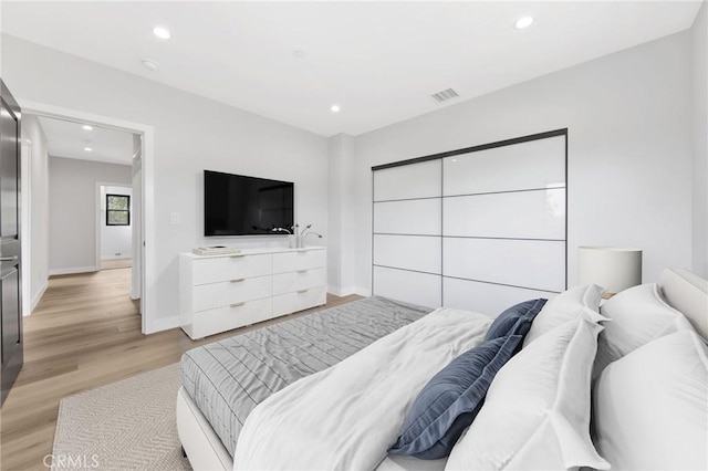 bedroom featuring a closet and light wood-type flooring