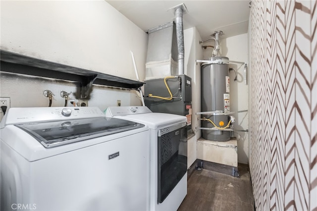 clothes washing area featuring separate washer and dryer, water heater, and dark hardwood / wood-style flooring