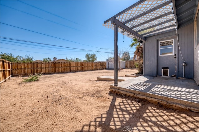 view of yard featuring a patio and a storage shed