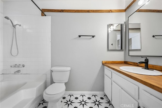 full bathroom with tiled shower / bath, vanity, and toilet