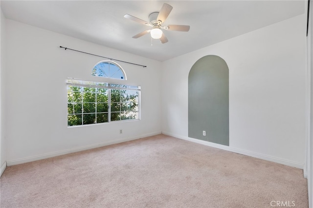 unfurnished room featuring light carpet and ceiling fan