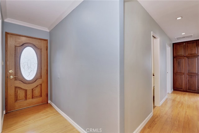 entrance foyer featuring light hardwood / wood-style floors and crown molding