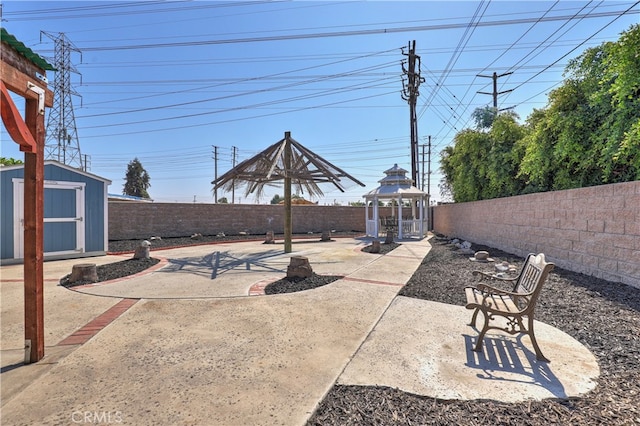 view of patio with a gazebo and a storage shed