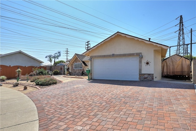 view of front facade featuring a garage and a storage unit