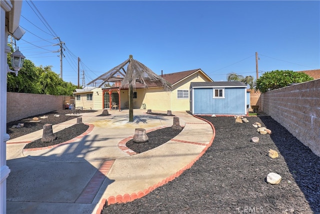 back of house featuring an outbuilding and a patio