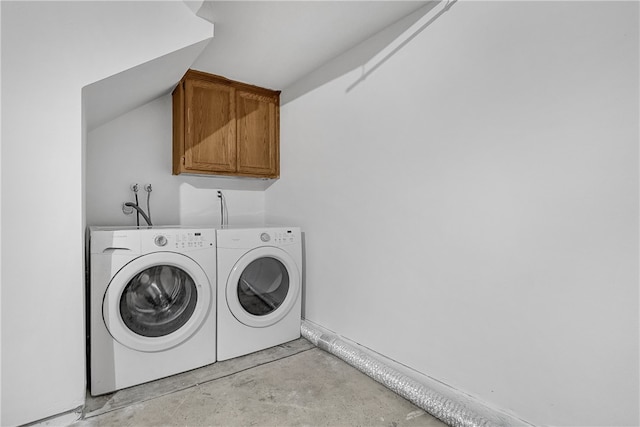 laundry area featuring separate washer and dryer and cabinets