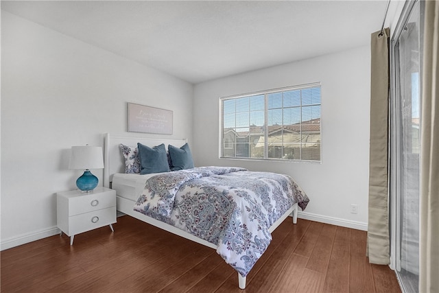 bedroom with dark hardwood / wood-style floors