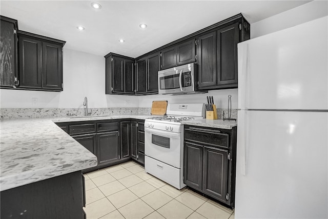 kitchen featuring light tile patterned floors, sink, and white appliances