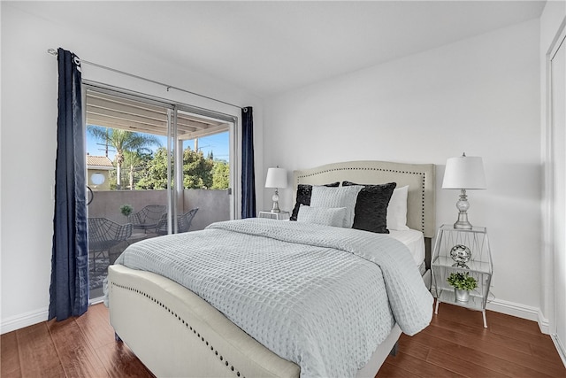 bedroom featuring dark hardwood / wood-style flooring and access to exterior