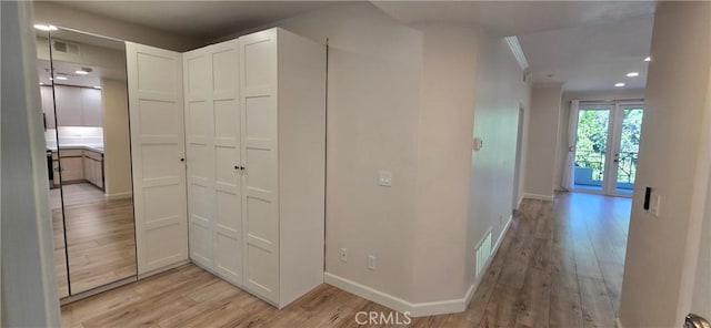 corridor with light hardwood / wood-style floors