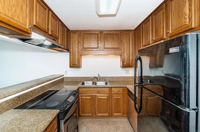 kitchen with stone counters, sink, light tile patterned floors, and black appliances