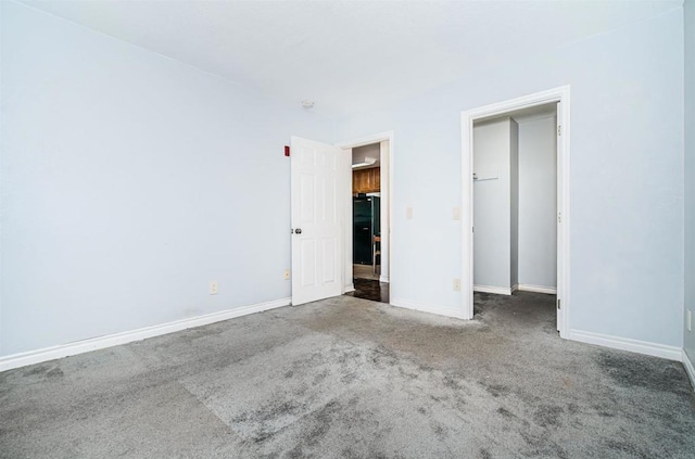 unfurnished bedroom featuring carpet and baseboards