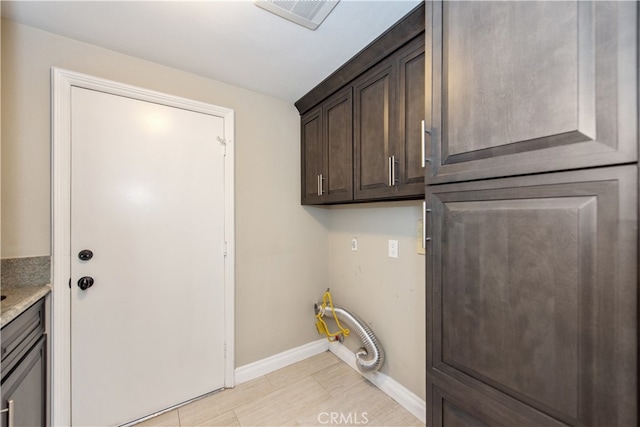 washroom featuring hookup for an electric dryer and light tile patterned floors