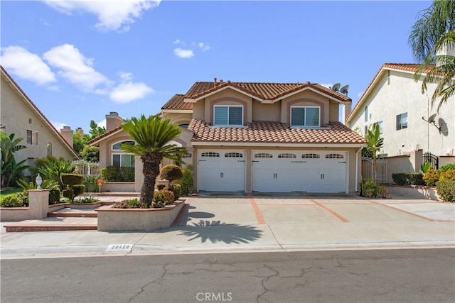 mediterranean / spanish-style home featuring a garage