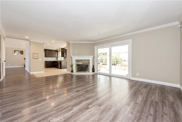 unfurnished living room with ornamental molding and light wood-type flooring