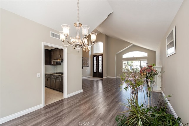 interior space featuring light hardwood / wood-style flooring, a chandelier, and high vaulted ceiling