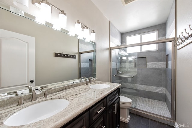 bathroom featuring vanity, toilet, and an enclosed shower