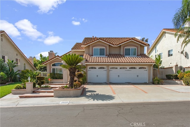 mediterranean / spanish-style house with a garage