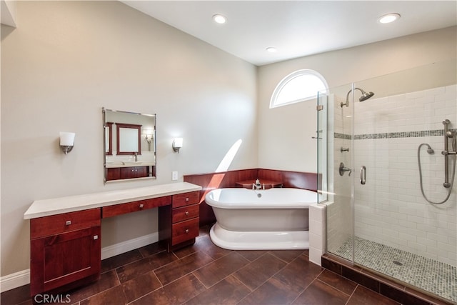 bathroom featuring vanity and shower with separate bathtub