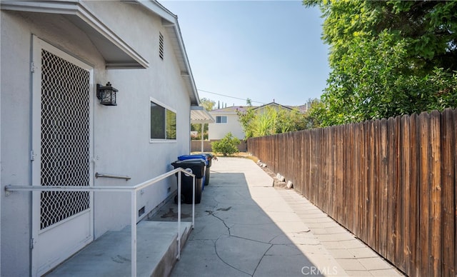 view of property exterior with a patio area