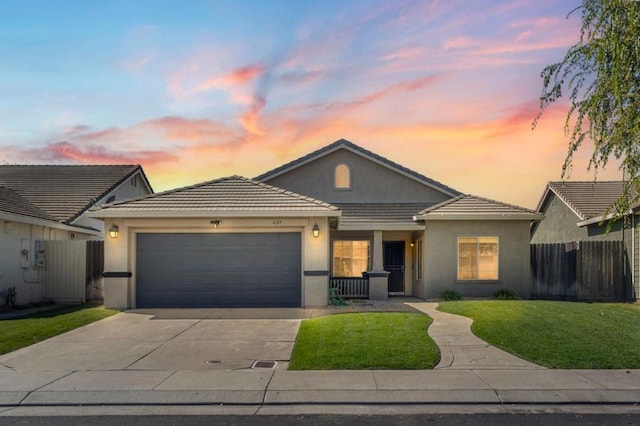 ranch-style house featuring a yard and a garage