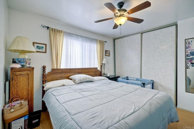 bedroom with ceiling fan, a closet, and hardwood / wood-style floors