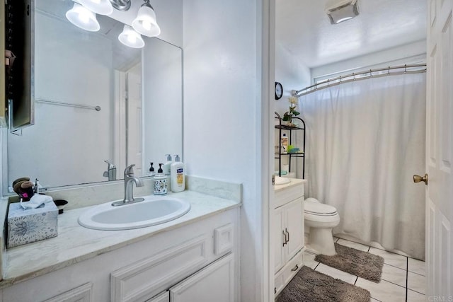 bathroom with vanity, toilet, and tile patterned floors