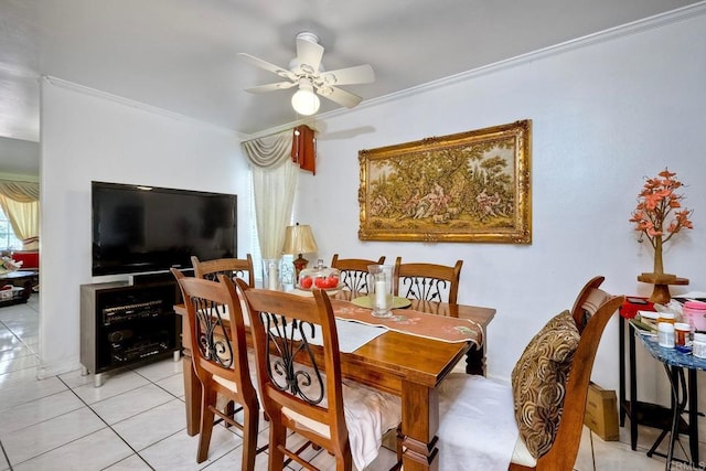 dining space featuring ceiling fan, crown molding, and light tile patterned floors