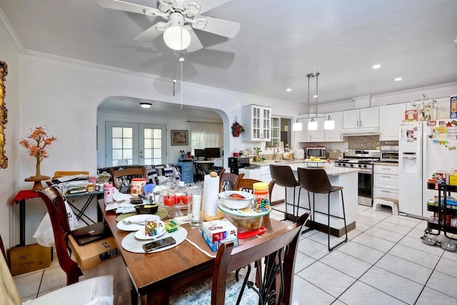 dining space featuring ornamental molding, ceiling fan, light tile patterned floors, and french doors