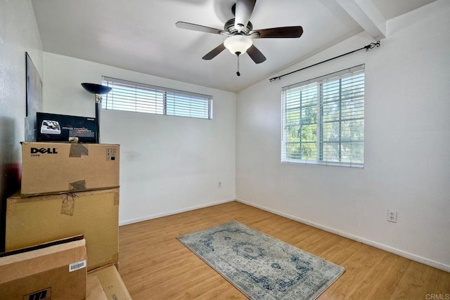 unfurnished room with wood-type flooring, lofted ceiling with beams, and ceiling fan