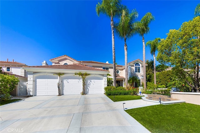 view of front of home with a garage and a front lawn